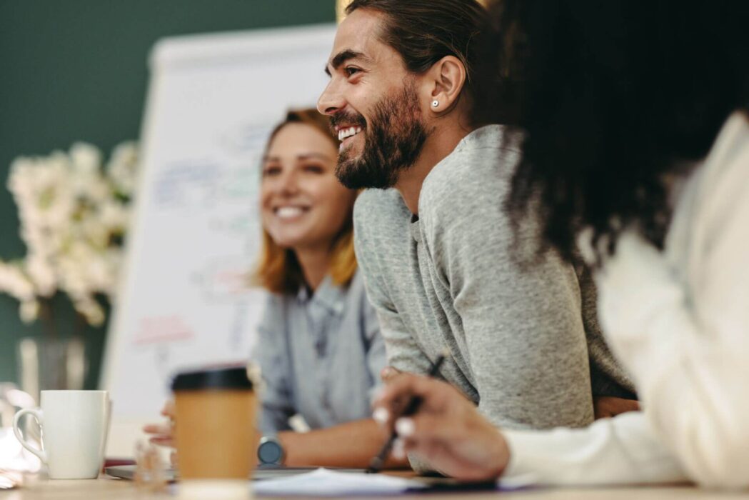 Workers smiling in meeting