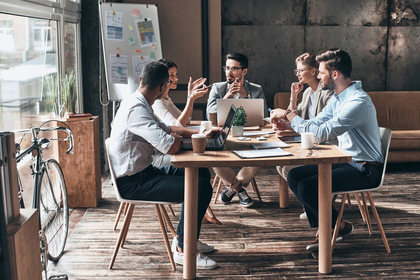 Workers sitting around a table in a meeting