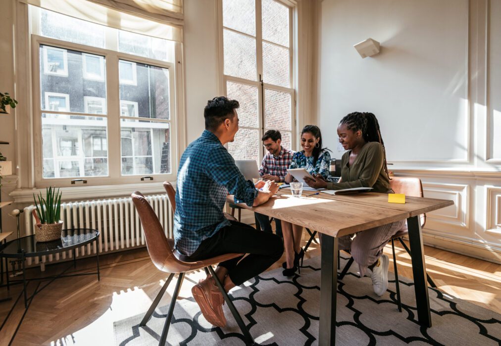 Workers smiling at table