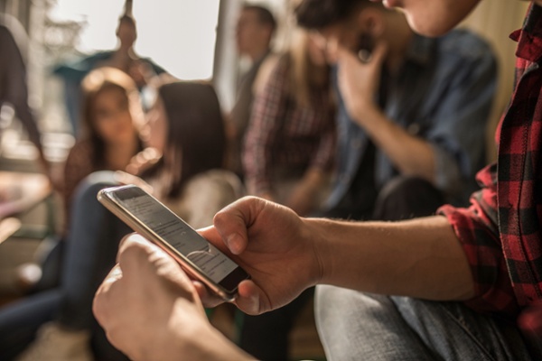 Person on mobile phone in crowded room