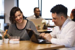 Two workers smiling with laptop