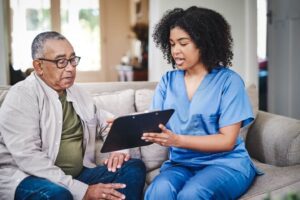 Nurse showing eldery person a clipboard